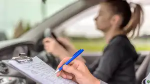 Driving examiner assessing a learner during a practical test