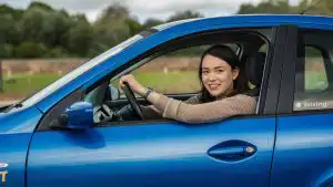 Female driving instructor giving a lesson in a car