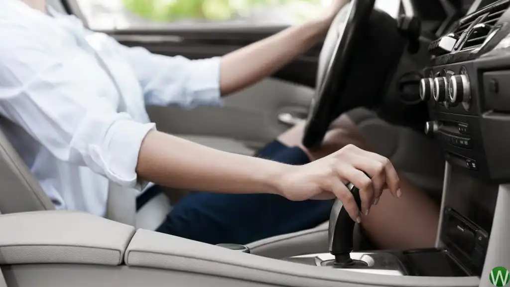 Driver selecting a gear in a manual car