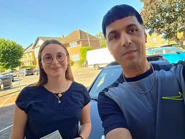 Maddie with instructor Cameron beside the car after passing her driving test